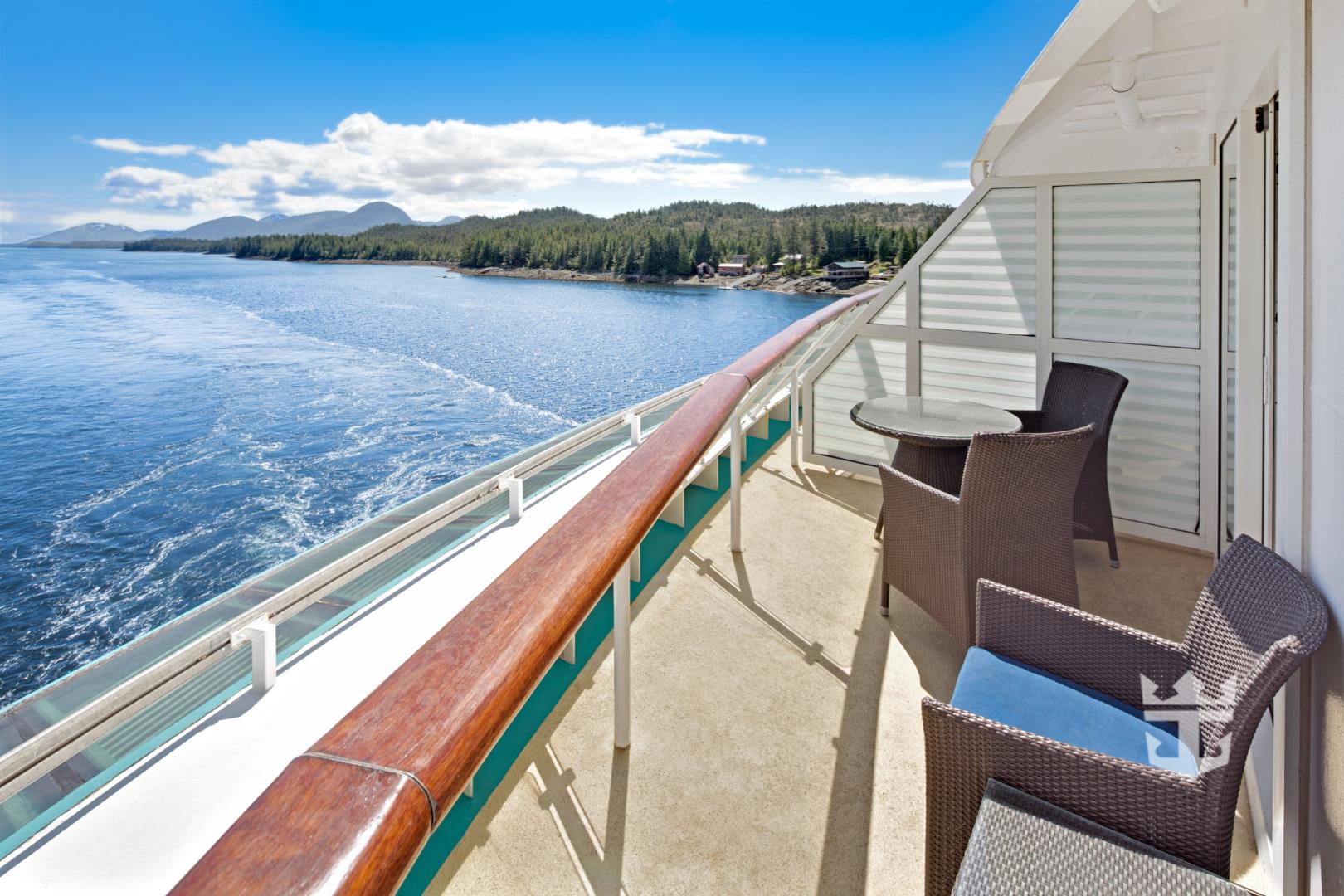 View of the ocean and seating on a two-bedroom suite balcony